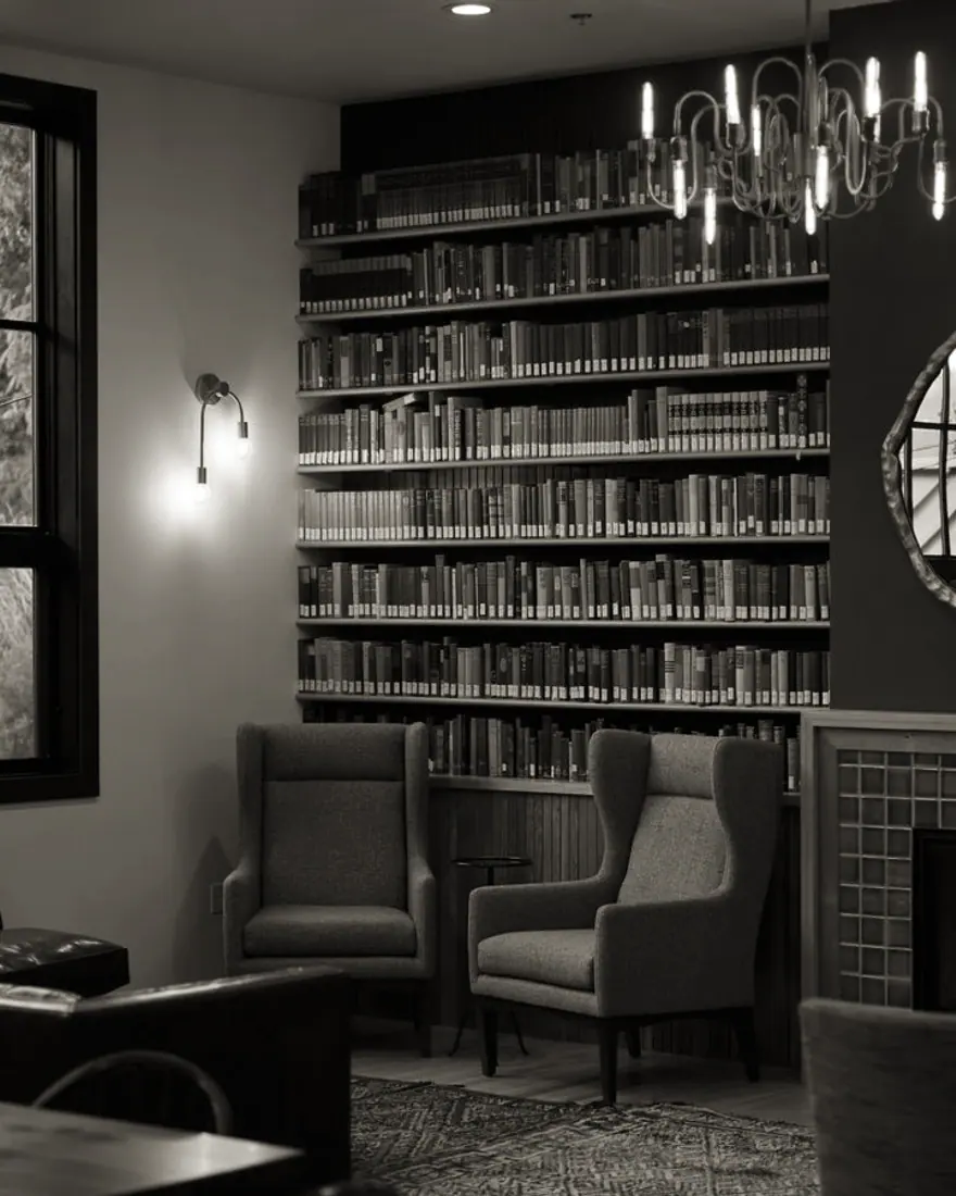 The firm&rsquo;s reading room: a wall of bound reports beside two quiet armchairs.
